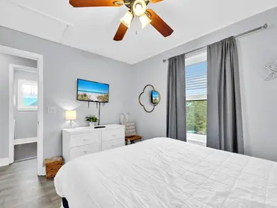 a bedroom with a white bed and a ceiling fan at Beachside Villas 1131 in Santa Rosa Beach