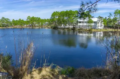 a view of a lake with a building in the background at Beachside Villas 1131 in Santa Rosa Beach
