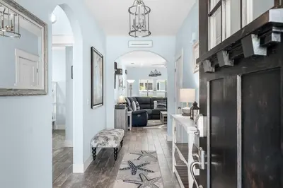 a living room with a couch and a table at Beach House - Lazee Daze by Panhandle Getaways in Panama City Beach