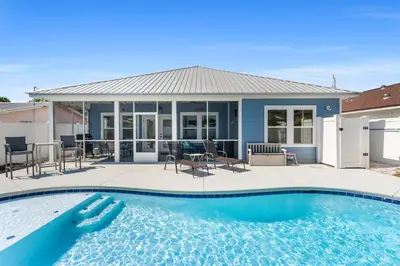 a swimming pool in front of a house at Beach House - Lazee Daze by Panhandle Getaways in Panama City Beach