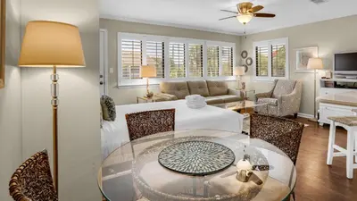 a living room with a glass table and a couch at Hidden Beach 201 in Santa Rosa Beach