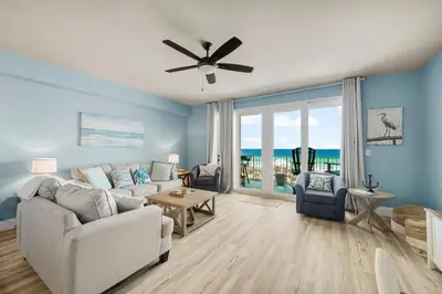 a living room with a couch and a ceiling fan at Laketown Wharf #0703 in Panama City Beach