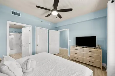 a bedroom with a bed and a flat screen tv at Laketown Wharf #0703 in Panama City Beach