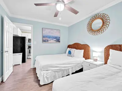 a bedroom with two beds and a ceiling fan at Beachside Villas 214 in Santa Rosa Beach