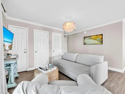 a living room with a couch and a fireplace at Beachside Villas 214 in Santa Rosa Beach