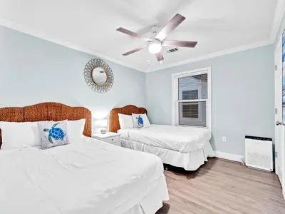 a bedroom with two beds and a ceiling fan at Beachside Villas 214 in Santa Rosa Beach