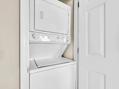 a white oven in a kitchen next to a door at Beachside Villas 214 in Santa Rosa Beach