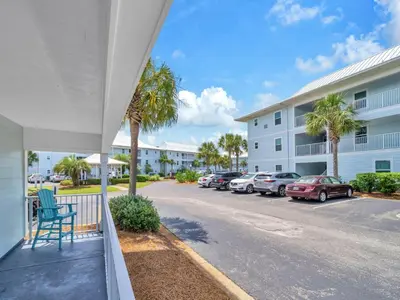a balcony of a apartment building with cars parked in a parking lot at Beachside Villas 214 in Santa Rosa Beach