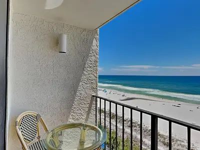 a balcony with a table and chairs and the beach at Edgewater Tower III #709 in Panama City Beach