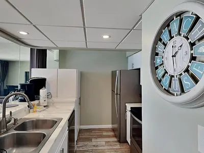 a kitchen with a large clock on the wall at Edgewater Tower III #709 in Panama City Beach