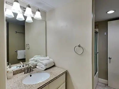 a bathroom with a sink and a mirror at Sunbird Beach Resort #902 West in Panama City Beach