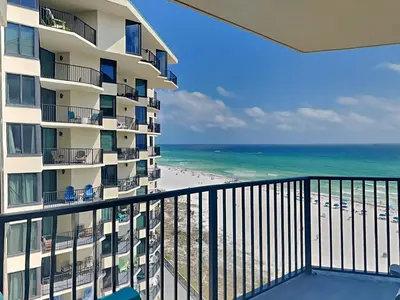 a view of the beach from the balcony of a hotel at Sunbird Beach Resort #902 West in Panama City Beach