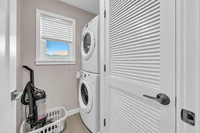 a white laundry room with a washer and dryer at Beachside Villas 523 in Santa Rosa Beach