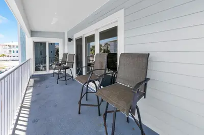 a porch with chairs and windows on a house at Beachside Villas 523 in Santa Rosa Beach