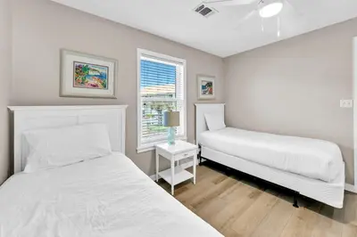 a bedroom with two beds and a window at Beachside Villas 523 in Santa Rosa Beach