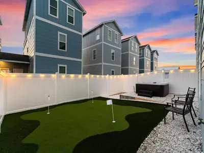 a patio with a miniature golf course in front of a building at Deja Blue in Panama City Beach