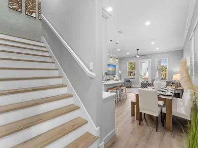 a staircase in a home with a dining room and living room at Deja Blue in Panama City Beach