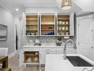 a kitchen with white cabinets and a sink at Deja Blue in Panama City Beach
