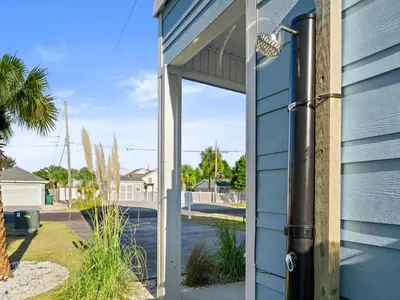 an open door to a blue house at Deja Blue in Panama City Beach