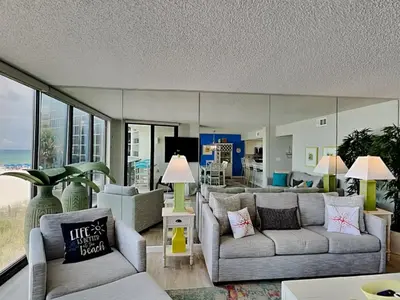 a living room with two couches and a view of the ocean at Edgewater Tower III #113 in Panama City Beach