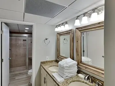 a bathroom with a sink and a mirror at Edgewater Tower III #113 in Panama City Beach