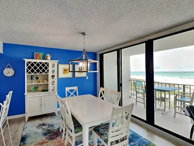 a dining room with a table and views of the ocean at Edgewater Tower III #113 in Panama City Beach