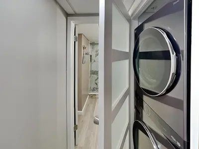 a bathroom with a round mirror on a door at Edgewater Tower III #113 in Panama City Beach