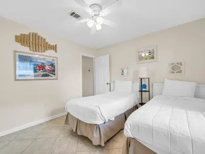 a bedroom with two beds and a ceiling fan at Beachside Villas 613 in Santa Rosa Beach