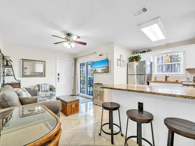 a kitchen and living room with a couch and a table at Beachside Villas 613 in Santa Rosa Beach