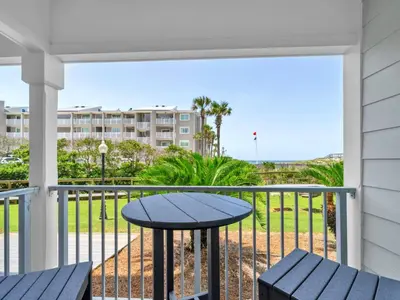 a patio with a table and chairs on a balcony at Beachside Villas 613 in Santa Rosa Beach