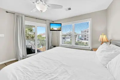 a bedroom with a large white bed and a window at Beachside Villas 823 in Santa Rosa Beach