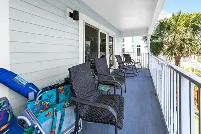 a porch with chairs and tables and aocked at Beachside Villas 823 in Santa Rosa Beach