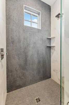 a bathroom with a shower with a window at 69 E Trigger Trail by 30A Escapes in Rosemary Beach