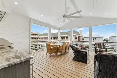 a patio with a table and chairs on a deck at 69 E Trigger Trail by 30A Escapes in Rosemary Beach