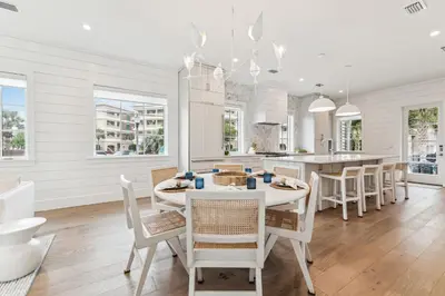 a kitchen and dining room with a table and chairs at 69 E Trigger Trail by 30A Escapes in Rosemary Beach