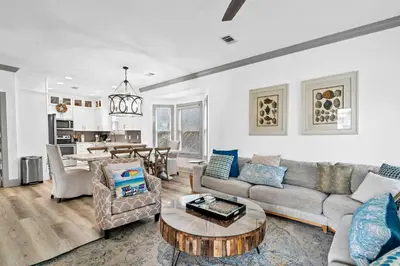 a living room with a couch and a table at Grouper Therapy in Santa Rosa Beach