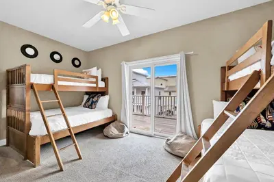a bedroom with bunk beds and a balcony at Grouper Therapy in Santa Rosa Beach