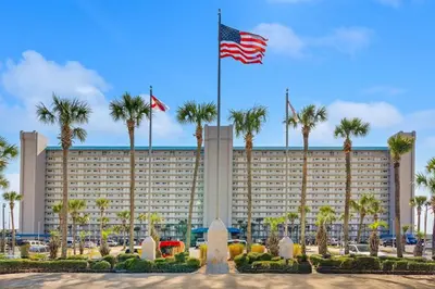 a large hotel with palm trees in front of it at The Summit Unit 1215 in Panama City Beach