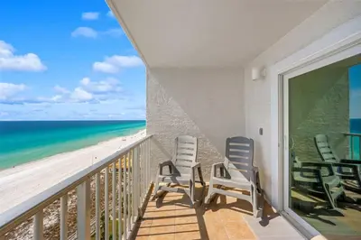 a balcony with chairs and a view of the beach at The Summit Unit 1215 in Panama City Beach
