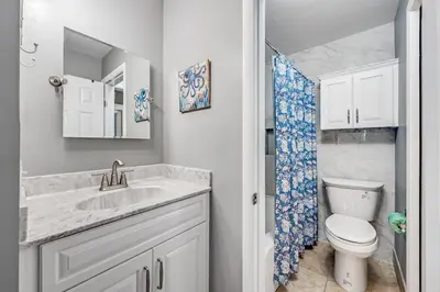 a white bathroom with a sink and a toilet at The Summit Unit 1215 in Panama City Beach