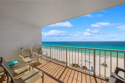 a balcony with chairs and a view of the beach at The Summit Unit 1215 in Panama City Beach