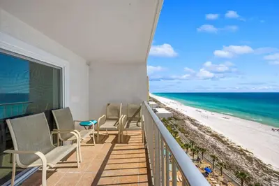 a balcony with chairs and a view of the beach at The Summit Unit 1215 in Panama City Beach