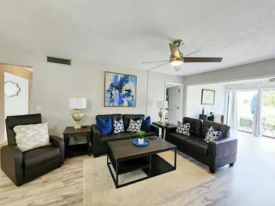 a living room with a couch and a table at Blue By The Bay in Panama City Beach