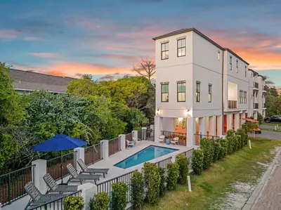 an exterior view of a building with a swimming pool at Casa DAzure by Travel Life Vacations in Santa Rosa Beach