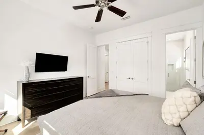 a white bedroom with a bed and a ceiling fan at Casa DAzure by Travel Life Vacations in Santa Rosa Beach