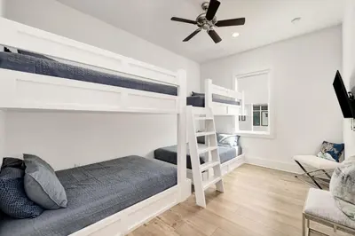 a bedroom with two bunk beds and a ceiling fan at Casa DAzure by Travel Life Vacations in Santa Rosa Beach