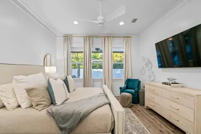 a bedroom with a bed and a dresser and a window at Gone Coastal by Travel Life Vacations in Seacrest