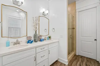 a white bathroom with a sink and a shower at Gone Coastal by Travel Life Vacations in Seacrest