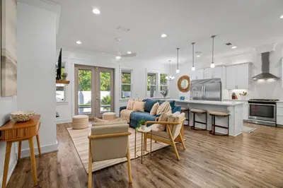 a living room with a couch and a kitchen at Gone Coastal by Travel Life Vacations in Seacrest