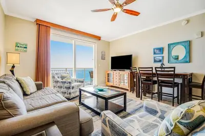 a living room with a couch and a table at Ocean Front Condo Panama City Beach in Panama City Beach